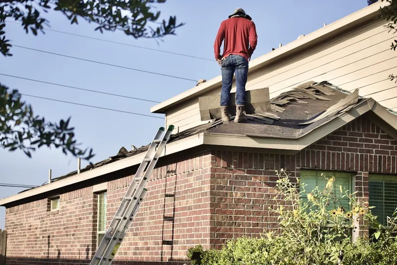 Professional roofer working on a residential roof in Dresher Woods